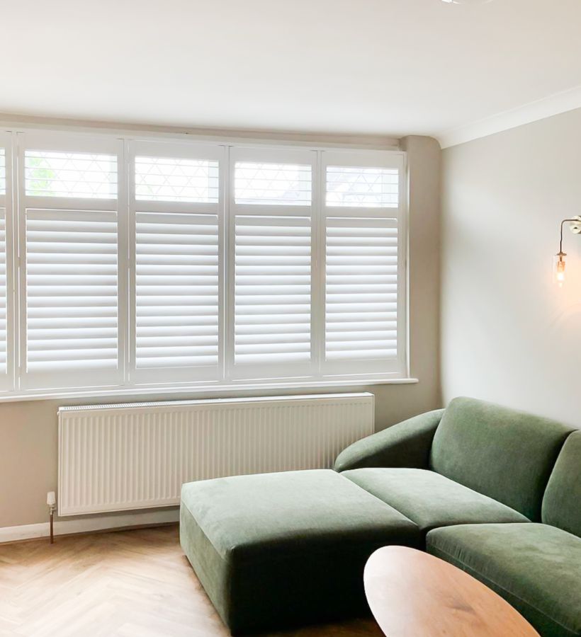 White café-style shutters in a contemporary living room