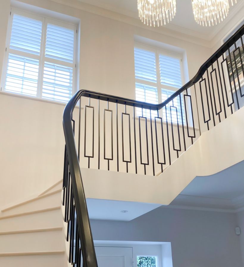 White plantation shutters on stairwell windows