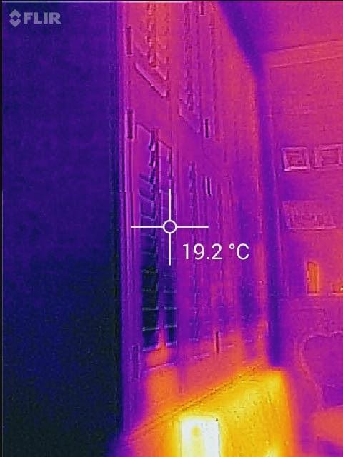 Thermal camera image of the same window with shutters and louvres closed, showing heat retained