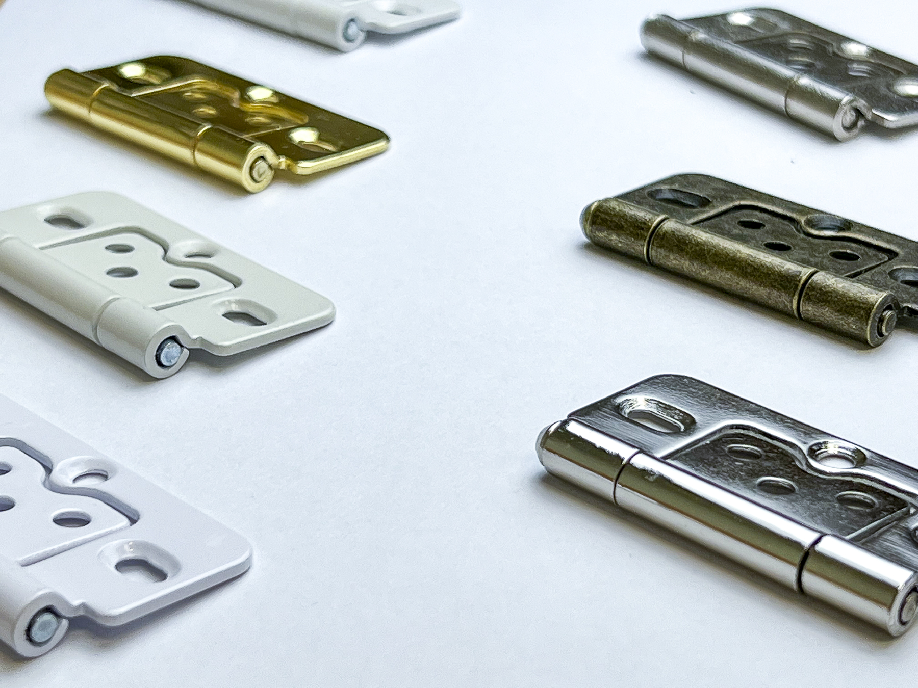 Selection of Hardwood+ hinge finishes: white, chrome, brass, gold and antique brass
