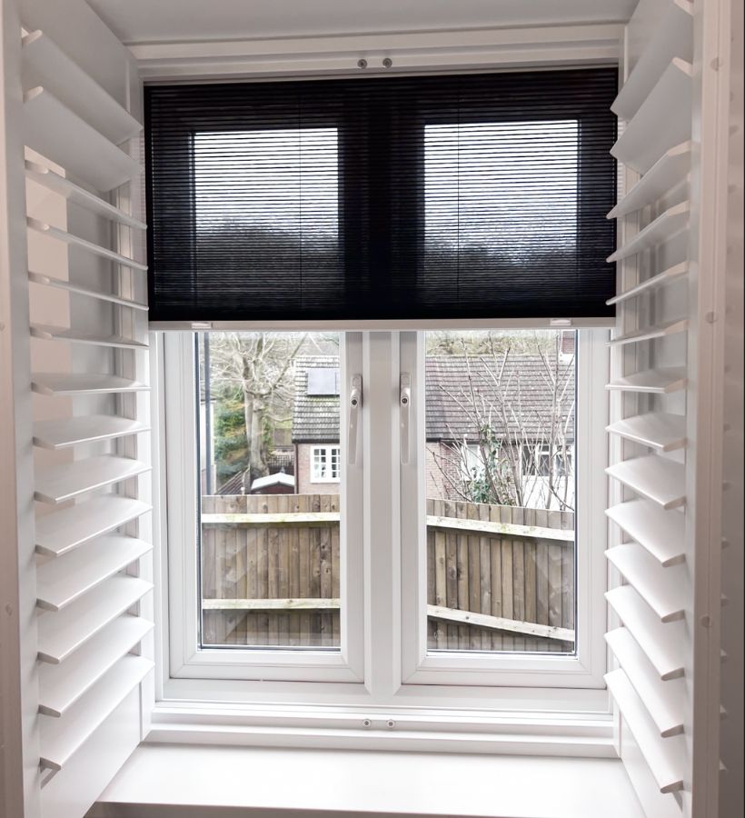 Shutters with a blackout blind fitted behind in a small window recess