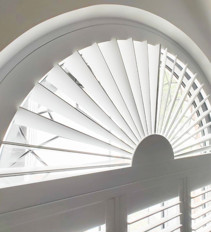 Bespoke fan-shaped shutter in an arched window